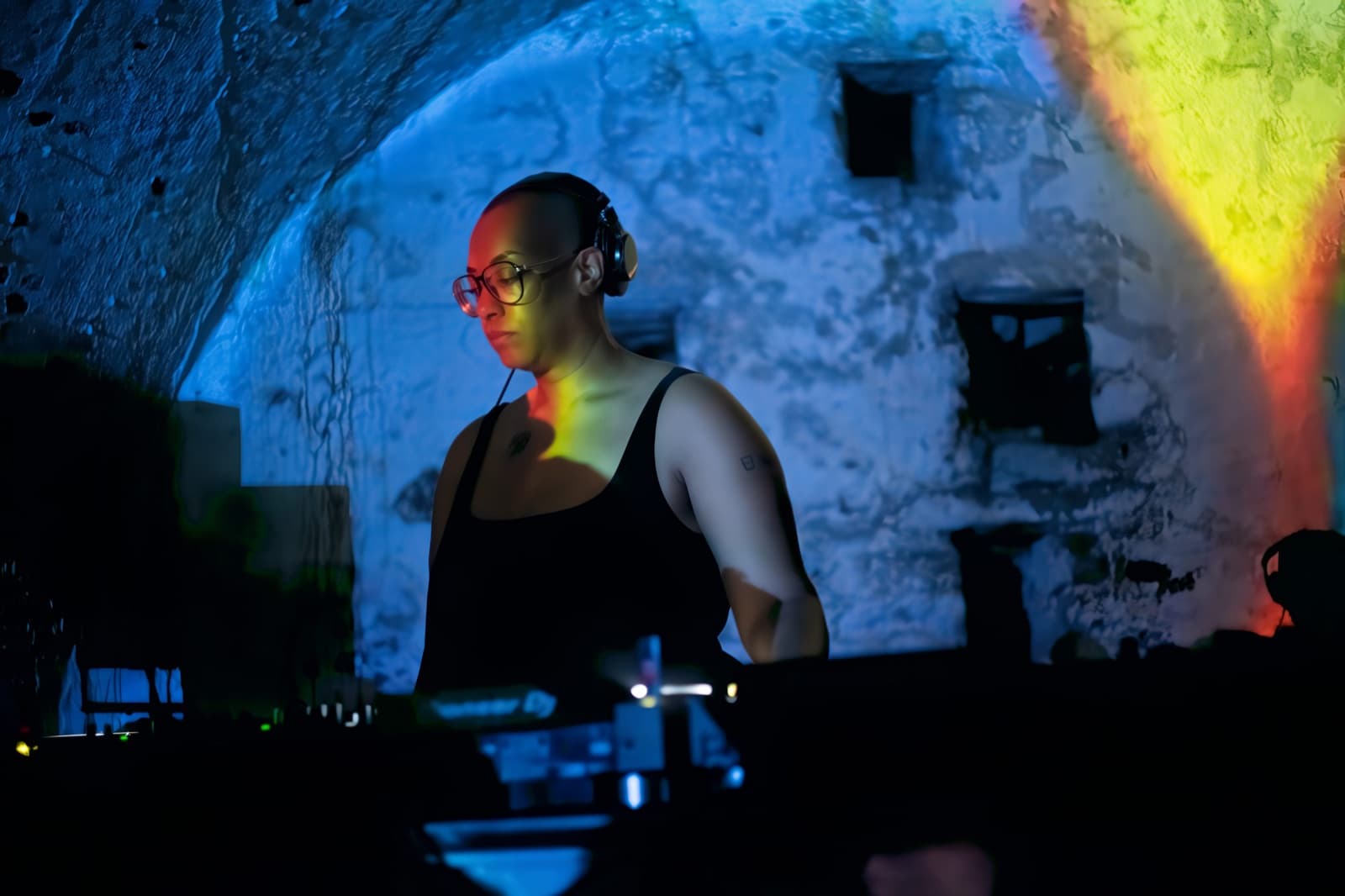 Sharlese DJing under projected light